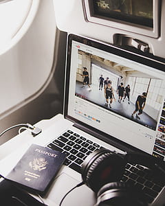 powered-on MacBook Pro with passport and wired headset on top thumbnail