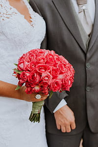bride holding red rose flower bouquet thumbnail