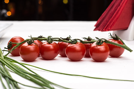 nine red tomatoes on white table thumbnail