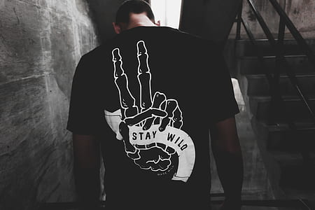 man wearing black and white Stay Wild-printed shirt thumbnail