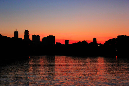 silhouette photo of high rise buildings during sunset thumbnail