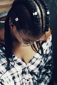 woman wearing black and white checkered dress shirt looking down while wearing eyeglasses thumbnail
