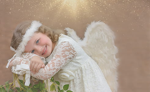 smiling girl wearing angel costume thumbnail