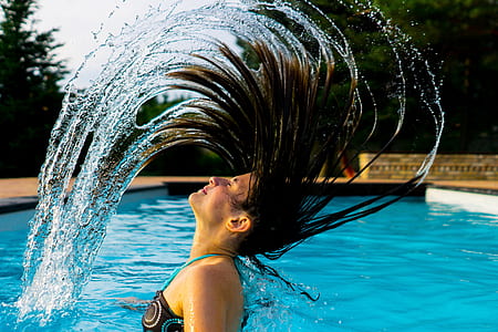 woman taking bath on swimming pool at daytime thumbnail