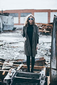woman standing on rusted metal bars thumbnail
