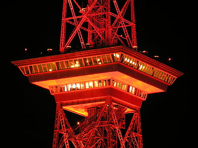 orange metal tower during nighttime thumbnail