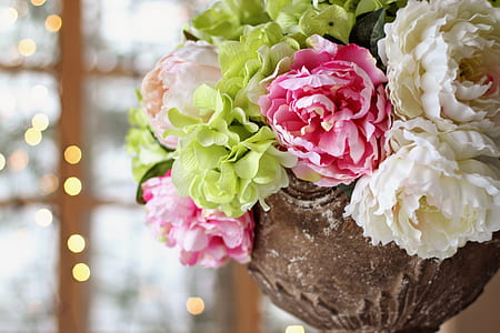 pink, green and white petaled flowers in brown metal vase thumbnail