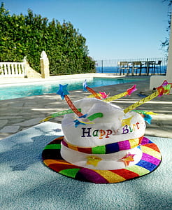 white, pink, and red hat on table thumbnail