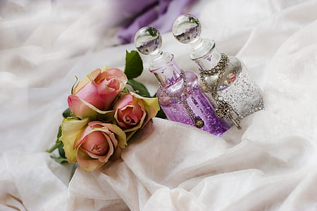 pink roses flowers and two clear glass bottles thumbnail