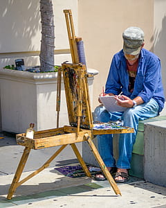 man writing on book thumbnail