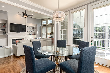 round clear glass-top dining table with chairs thumbnail