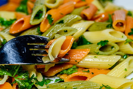 close-up photography of penne pasta with green parsley toppings thumbnail