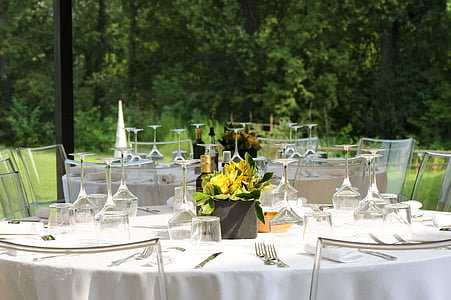 wine glasses on table top with flower arrangement thumbnail