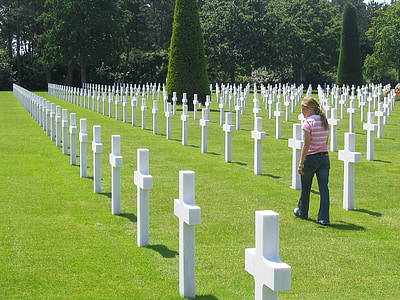 woman walking on green grass near grave thumbnail