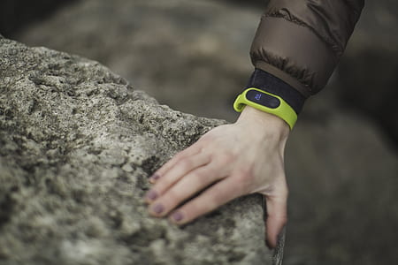 person wearing green fitness tracker thumbnail