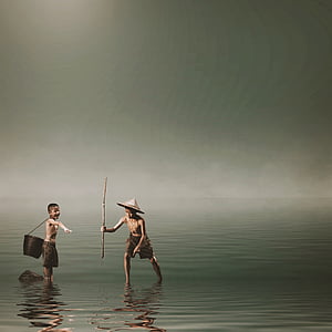 two boys catching fish on beach thumbnail