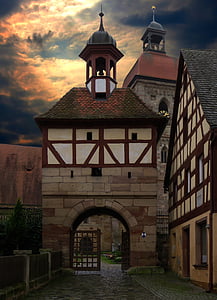 brown gateway tower near house thumbnail