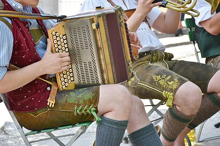 person sitting on chair playing musical instrument thumbnail