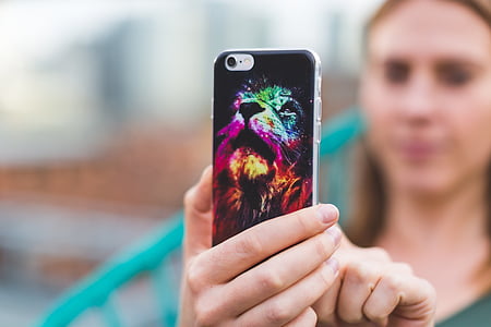 woman holding iPhone thumbnail