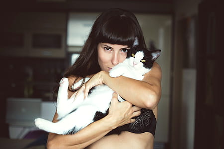 woman hugging black and white Tabby cat thumbnail
