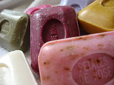 person taking a photo of assorted colored soaps thumbnail