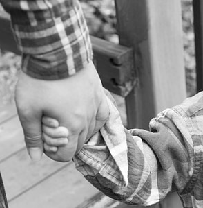 grayscale photo of two person holding hands thumbnail