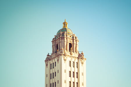 beige and white concrete building under blue sky thumbnail