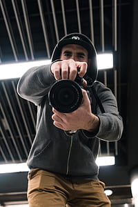 man holding black DSLR camera thumbnail