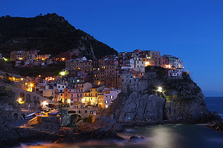 white lighted houses on top of cliff thumbnail