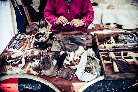 person sitting infront assorted-color weapon on table thumbnail