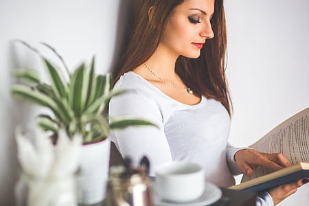 woman in white shirt reading book thumbnail