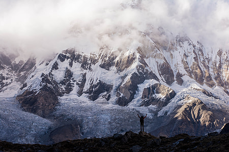person standing on mountain during daytime thumbnail