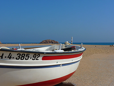 white, red, and blue boat at seashore during daytime thumbnail