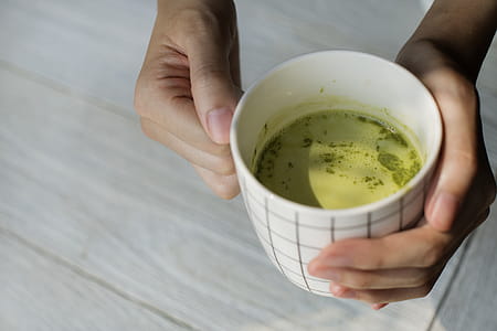 Close-up Photography of Person Holding Ceramic Mug thumbnail
