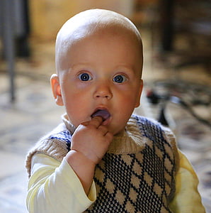 baby biting its finger thumbnail