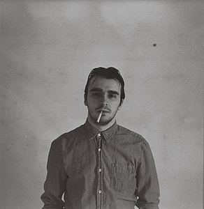 grayscale image of man with cigarette on his mouth thumbnail