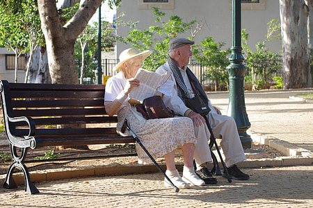 old man and woman on wooden bench thumbnail