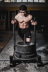 Man Pushing Cart With Weight Plates thumbnail