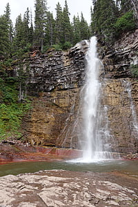 waterfalls under pine trees thumbnail