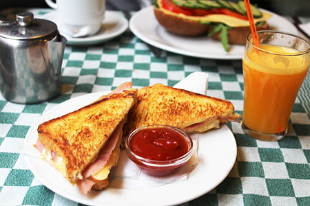 two sandwich slices on plate with ketchup thumbnail