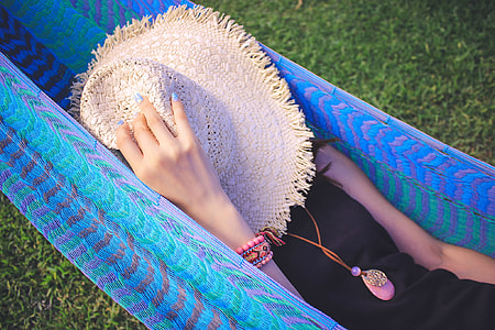 woman wearing black dress lying on blue hammock thumbnail