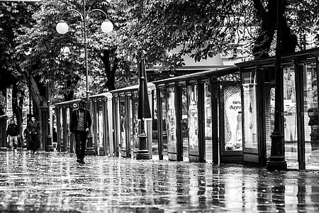 grayscale photography of man walking thumbnail