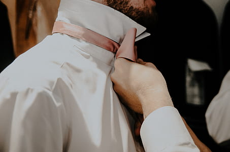 person fixing men's necktie thumbnail