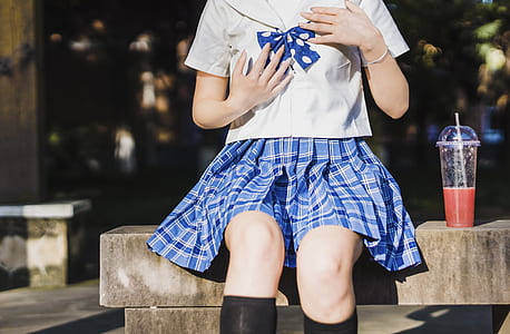 woman sitting on bench beside disposable cup thumbnail
