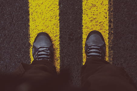 Person in Gray Sneakers Standing on Pedestrian Lane thumbnail
