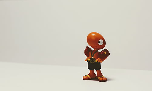 brown animal figurine standing on white table thumbnail