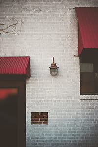 brown sconce on bricked wall thumbnail