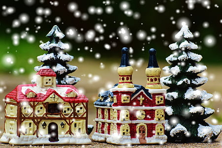 two brown-and-red ceramic house miniatures beside snow covered pine trees thumbnail