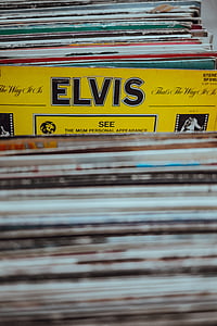 Elvis Presley record sleeve in between pile of record sleeves thumbnail