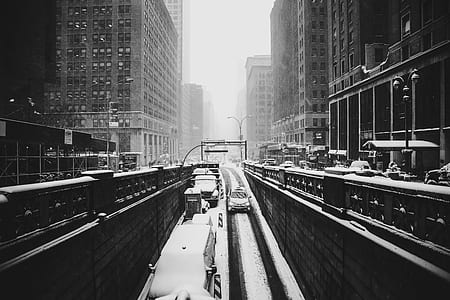 busy road between high-rise buildings thumbnail